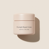Overnight Repair Cream premium studio hero shot on #F4F0ED background