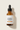 Close-up of Vitamin C Brightening Serum amber glass bottle and luxury label