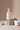 Nourishing Body Wash on stone pedestal with eucalyptus leaves and folded towel